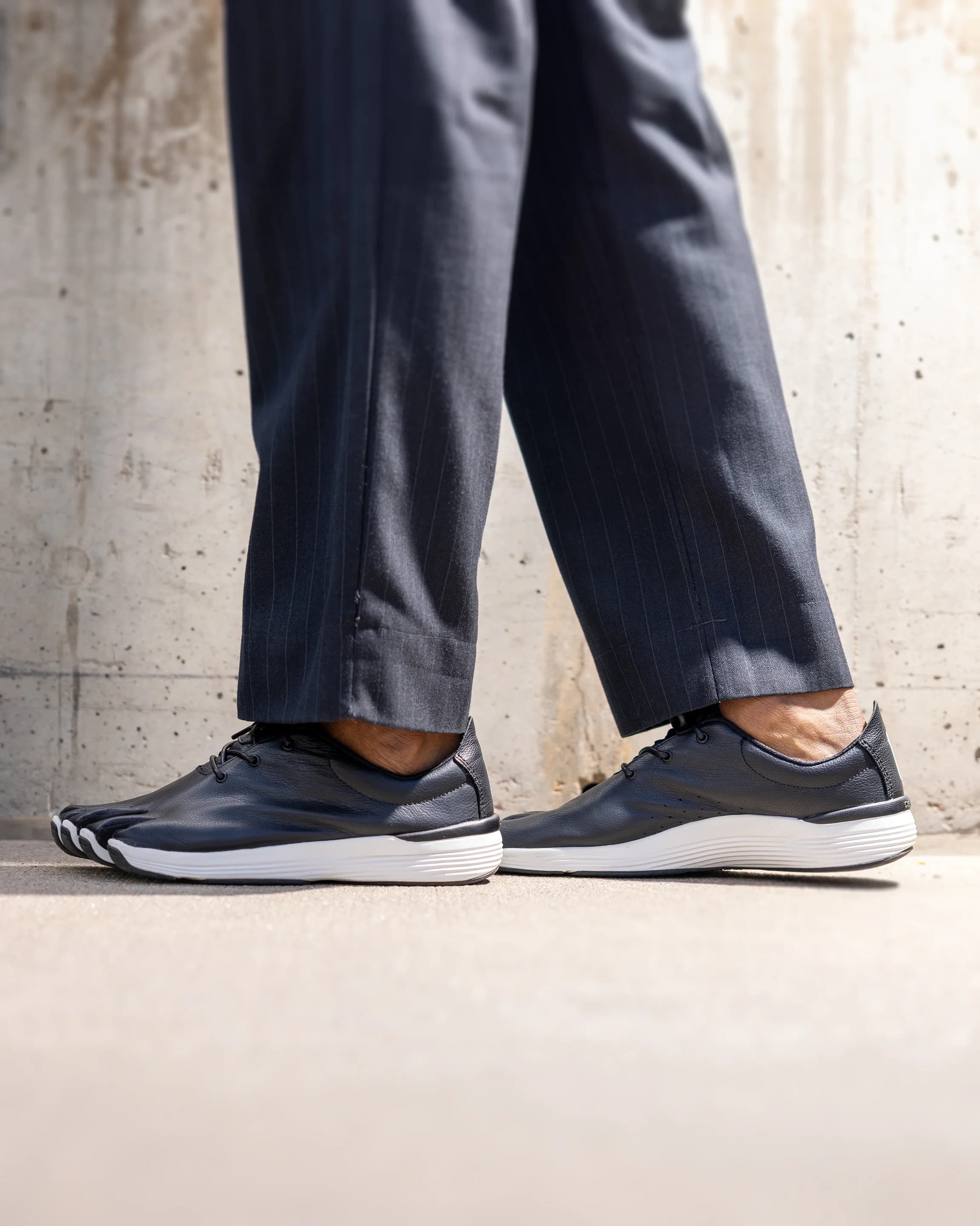 Person wearing Peluva dress shoes in a modern office setting